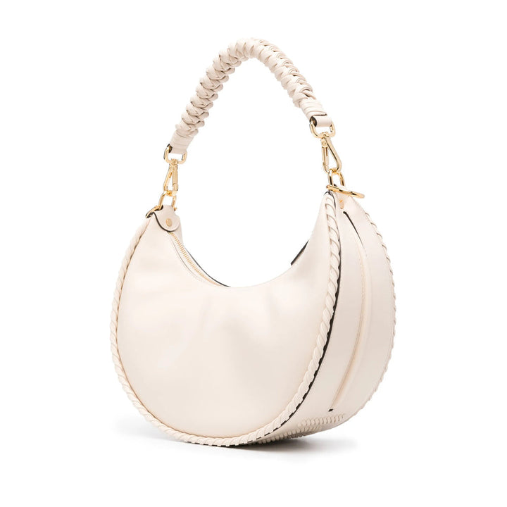 White handbag with braided handle on a white background
