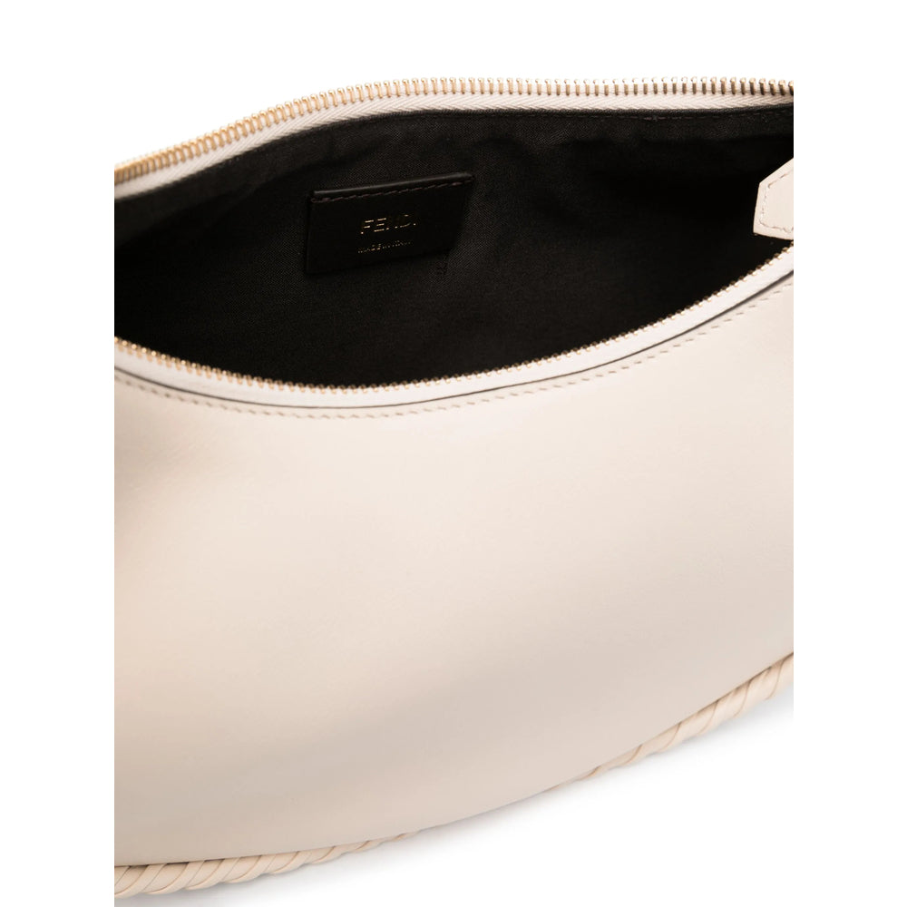 Beige clutch bag with black interior on a white background