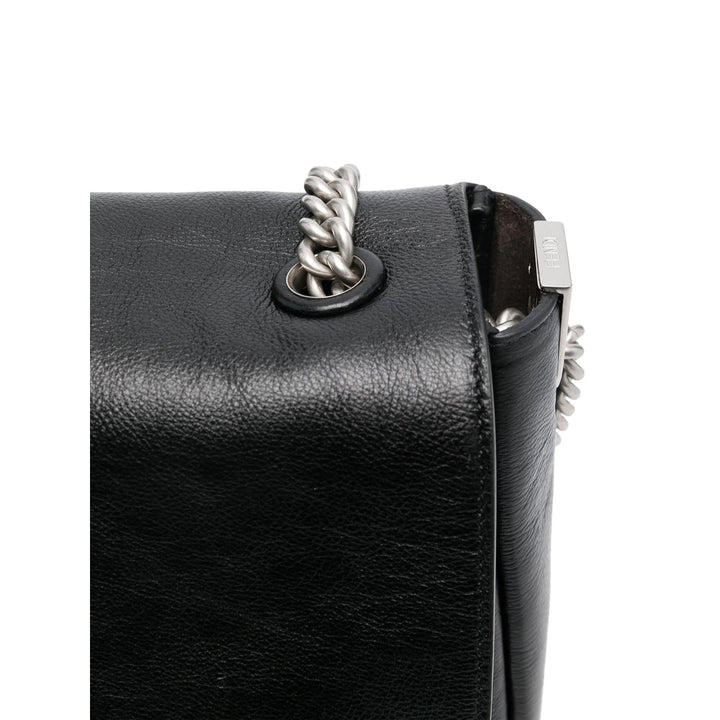 Black leather handbag with silver clasp and chain detail on a white background