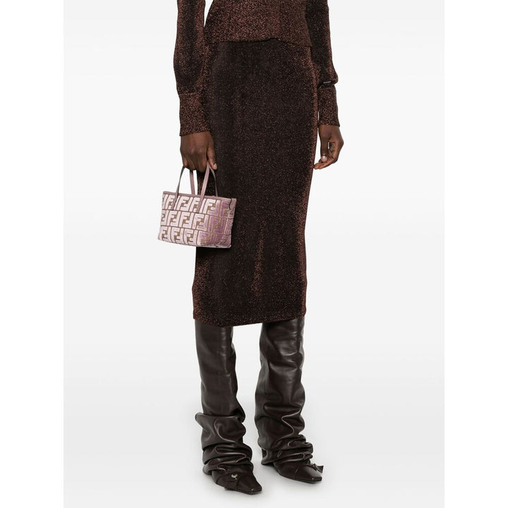 Person wearing a brown textured outfit with a matching bag on a white background