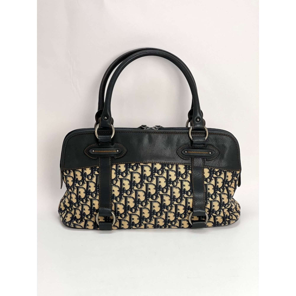CHRISTIAN DIOR Monogram Trotter CD Blue Canvas Hand Bag shown from side, luxury bags with black leather accents and violin print.