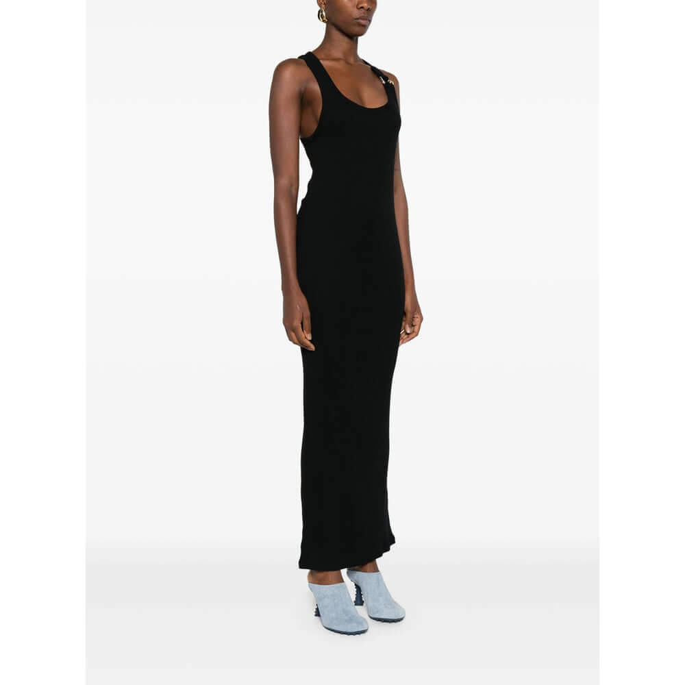 Woman wearing a black sleeveless dress on a white background