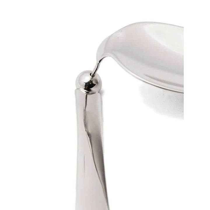 Close-up of a silver chair armrest on a white background