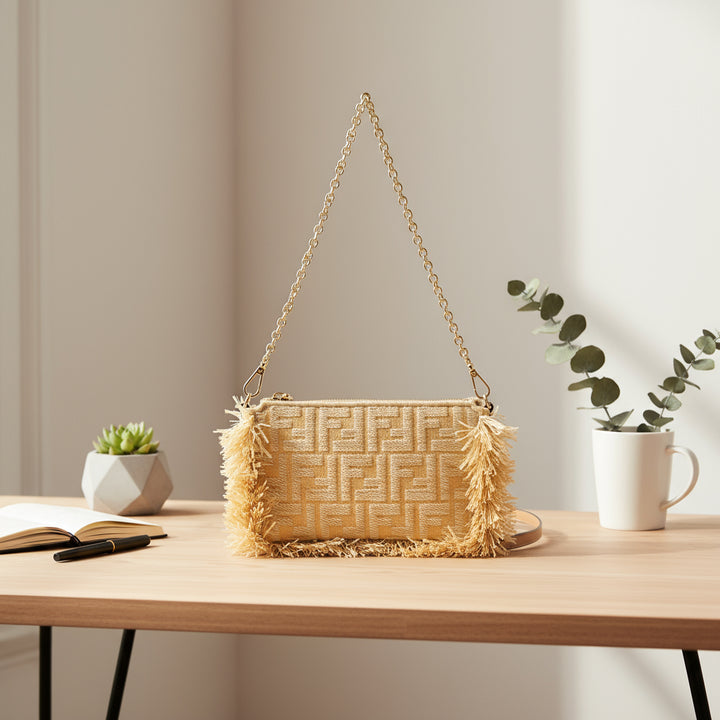 Beige handbag with chain strap and fringes on a white background