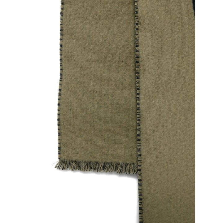 Green fabric with frayed edge on a white background