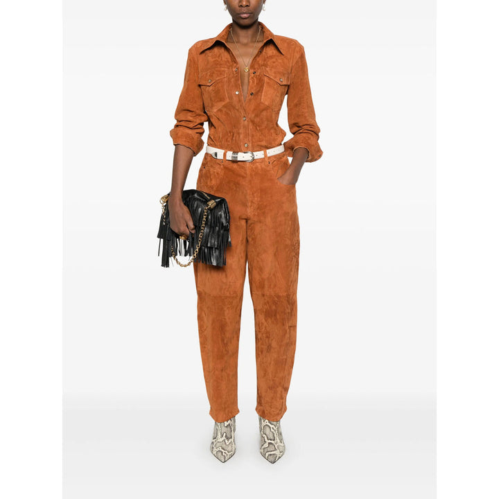Person wearing a brown suede jumpsuit on a white background