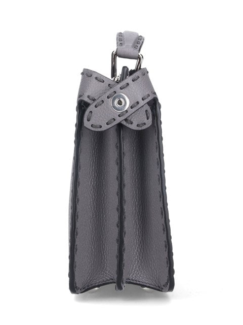 Black leather pouch with gray strap on a white background