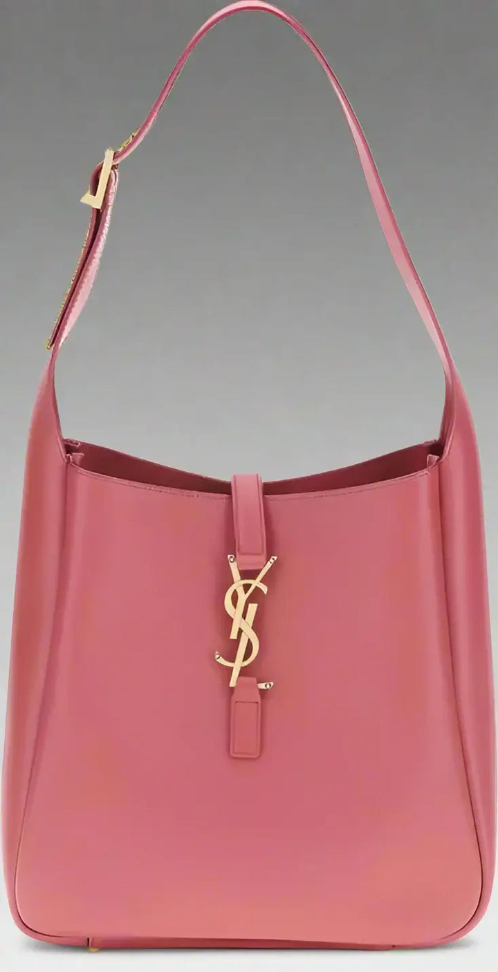 Pink handbag with a gold logo on a white background