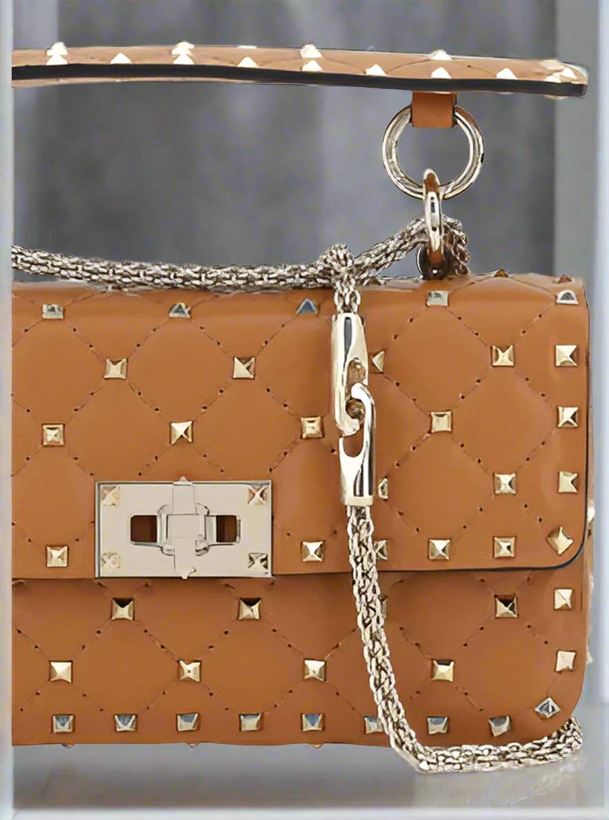 Valentino Garavani women's designer handbag in leather Luxury Valentino Garavani shoulder bag with iconic studs Valentino Garavani crossbody bag in black with gold accents