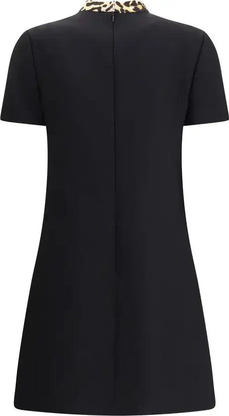 Black dress with a leopard print trim on a white background