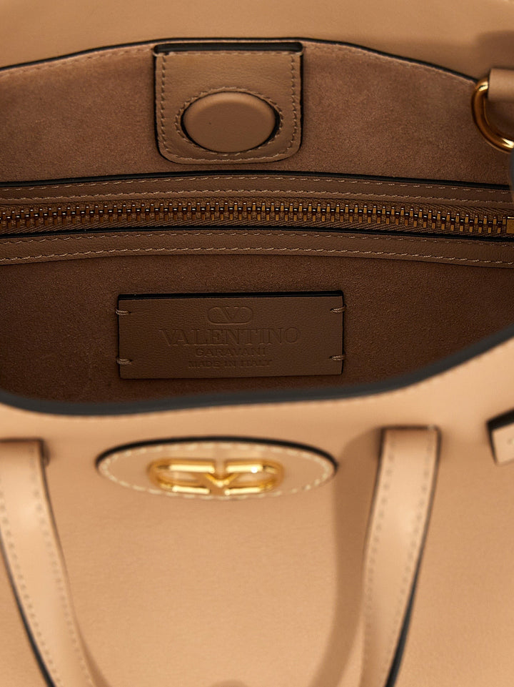 Close-up of a brown leather bag with a visible brand logo.
