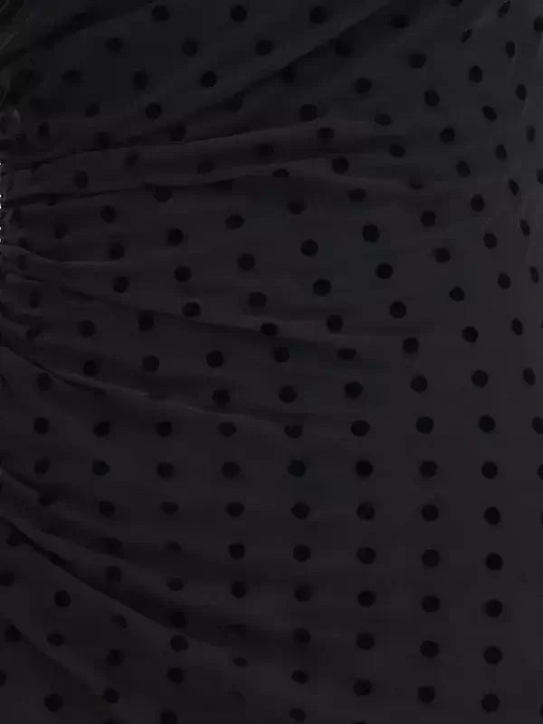 Close-up of a black polka dot fabric texture