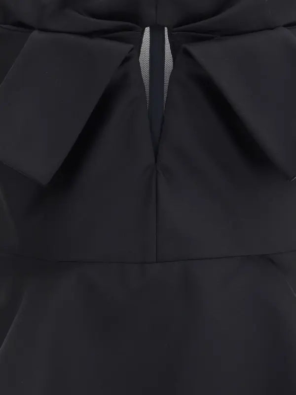 Close-up of a black garment with a bow detail