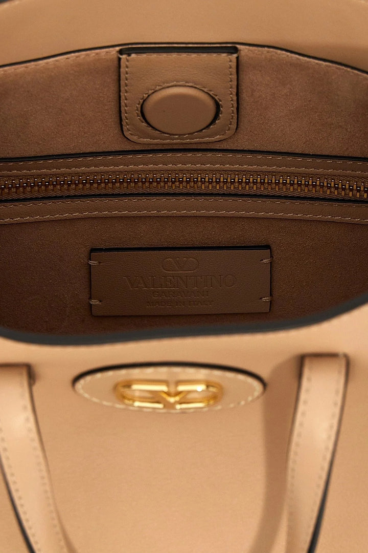 Close-up of a brown leather bag with a visible brand logo.