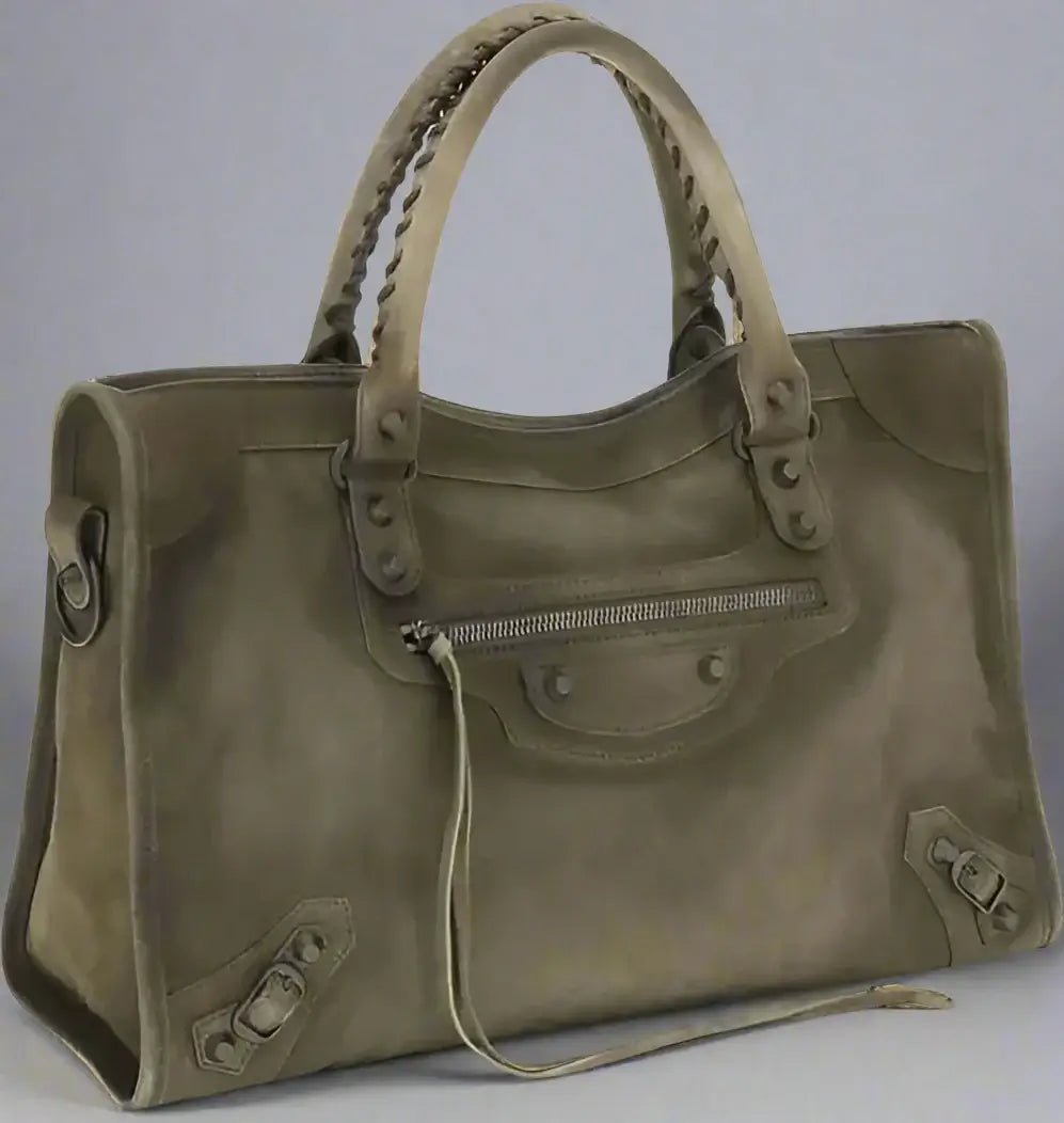 Green handbag with leather accents on a white background