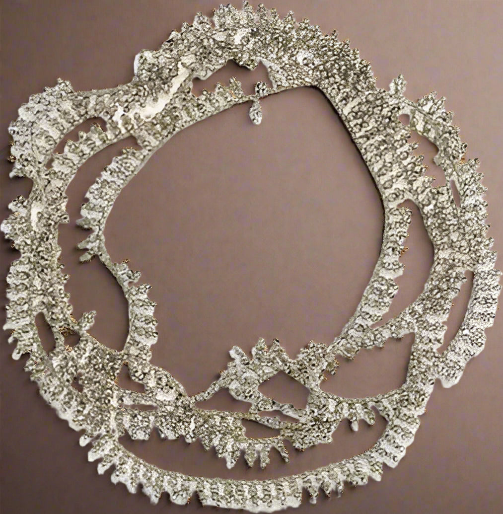 Silver necklace with intricate design on a white background