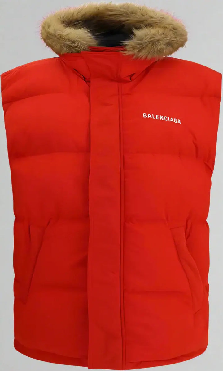 Red puffer vest with fur hood and Balenciaga branding on a white background