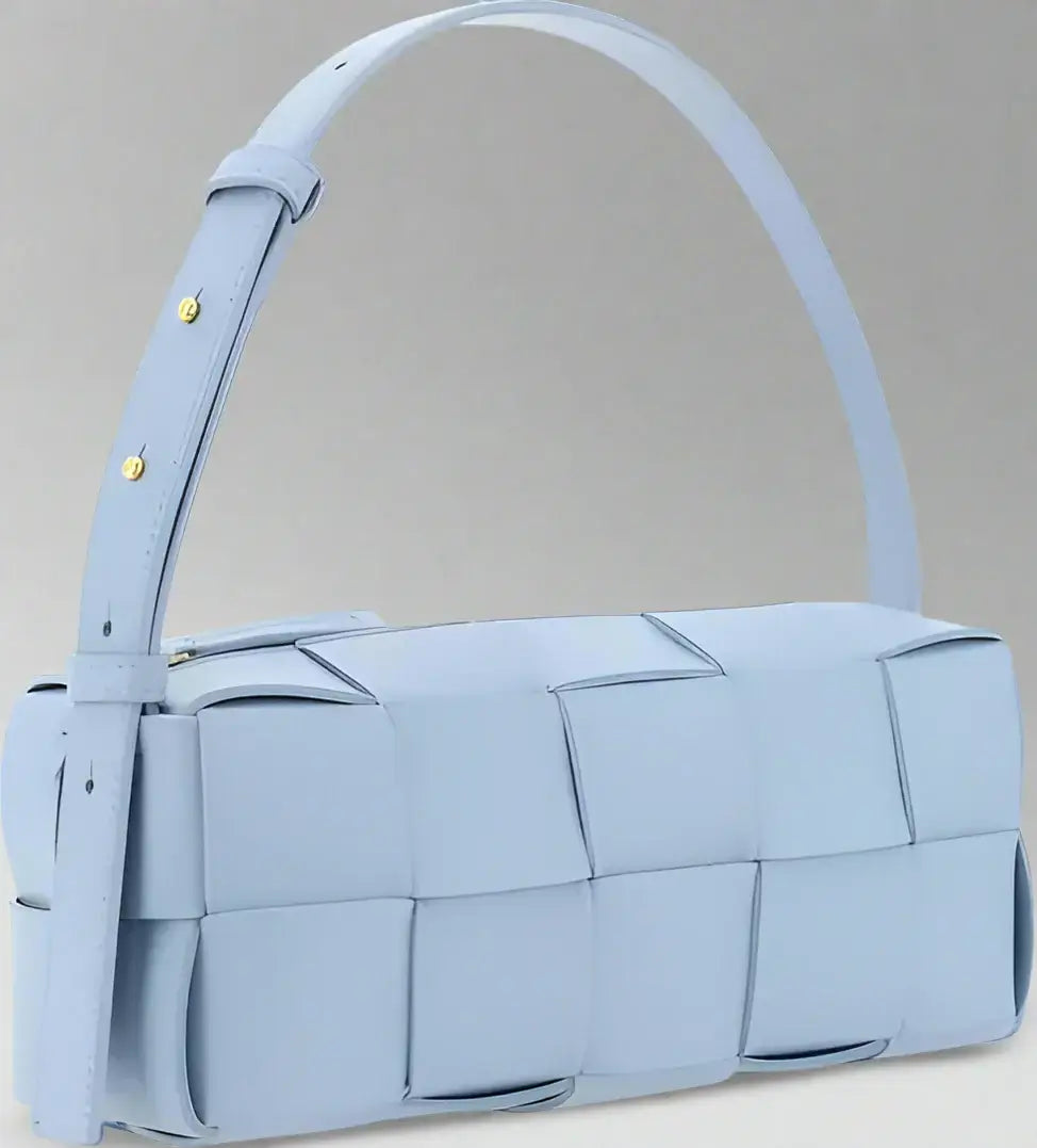 Light blue woven handbag with a handle on a white background