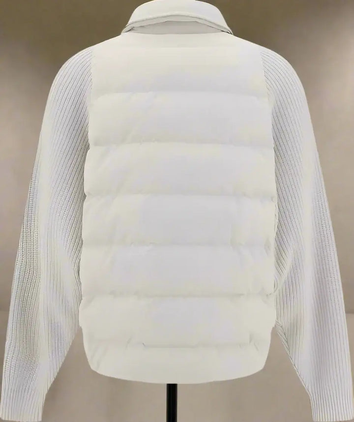 Light gray puffer jacket with ribbed sleeves on a white background