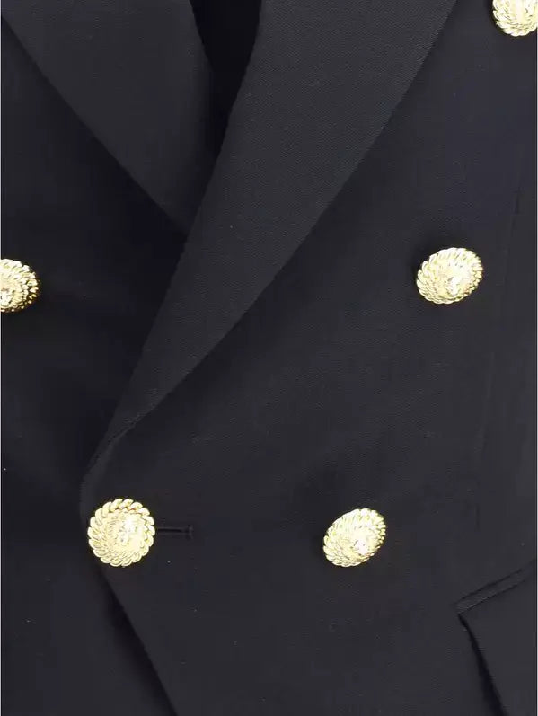 Close-up of a black coat with gold buttons