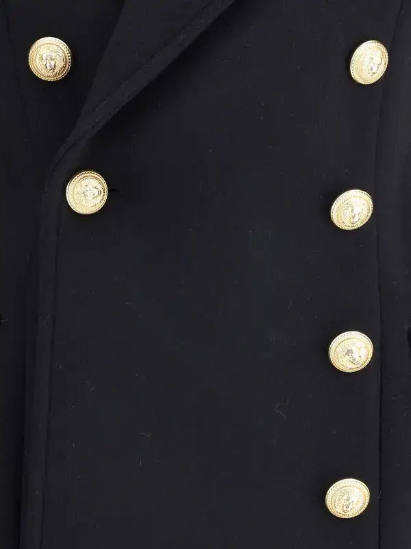 Close-up of a black coat with gold buttons