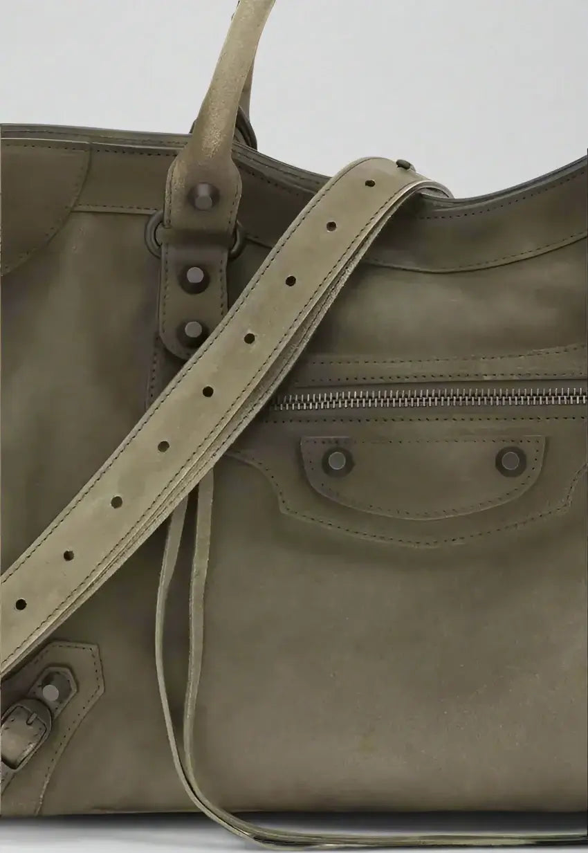 Green leather bag with strap on a white background