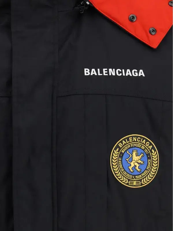 Black jacket with Balenciaga logo and emblem on a dark background