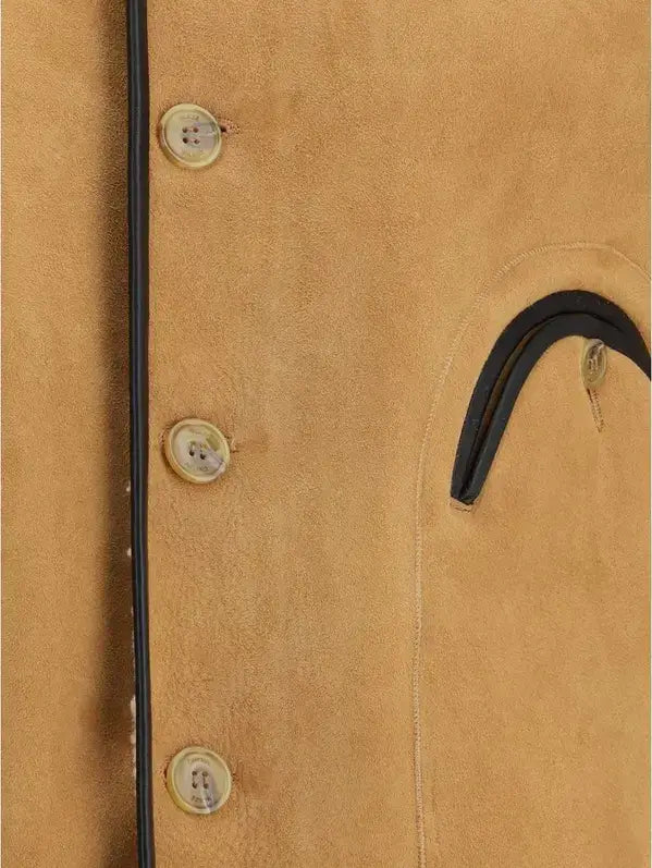 Close-up of a beige coat with buttons and black trim