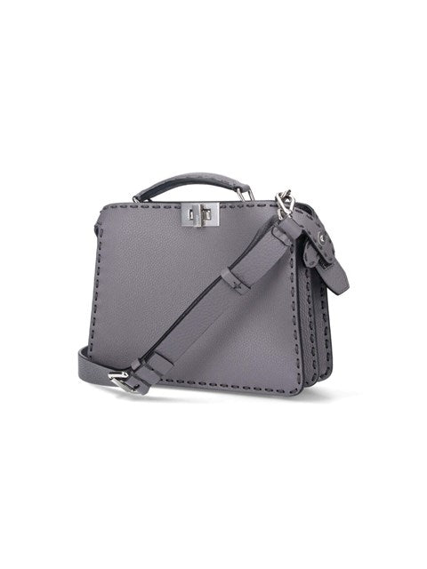 Gray handbag with a shoulder strap on a white background