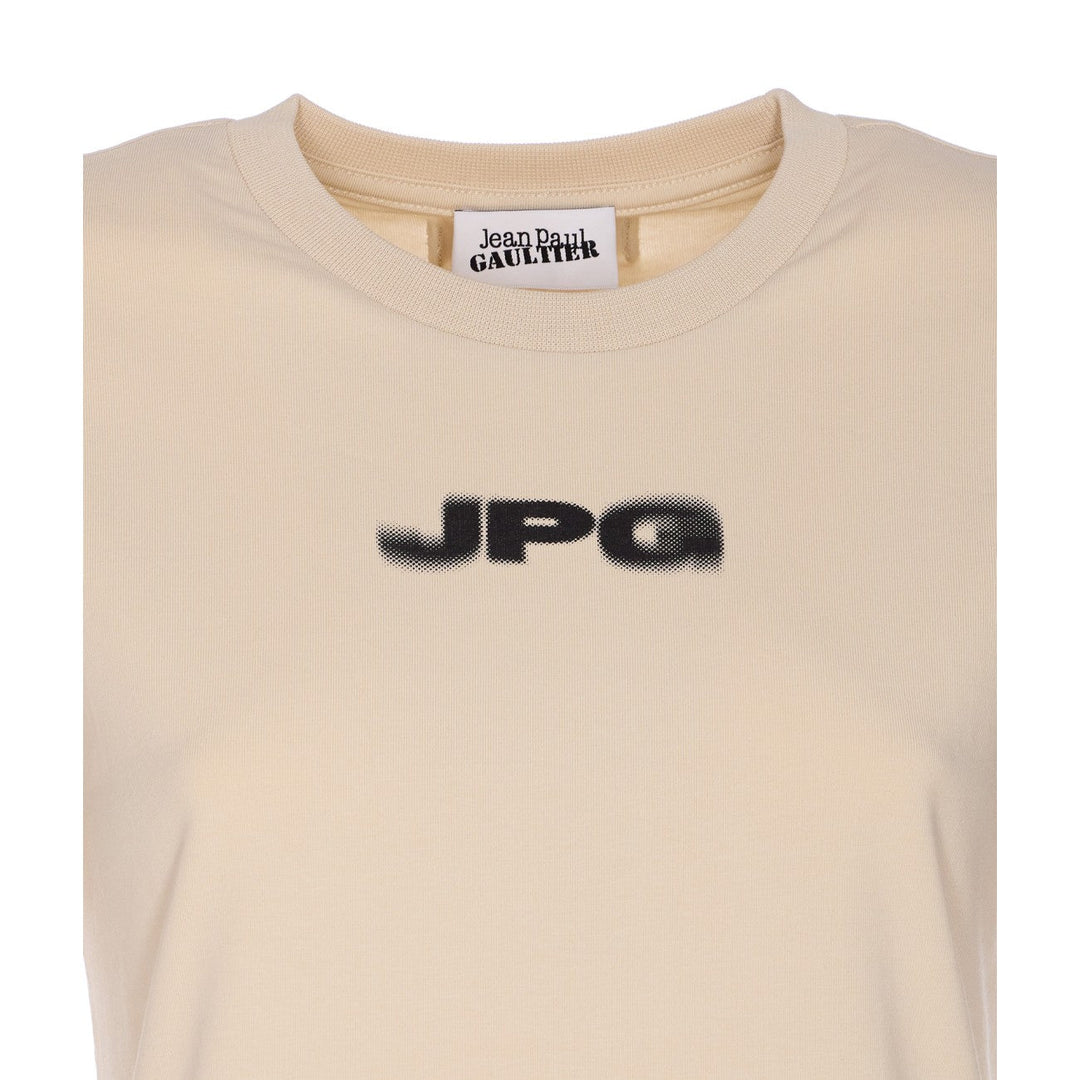 Beige t-shirt with 'JPG' logo and 'Jean Paul Gaultier' label on a white background