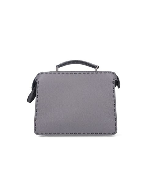 Gray leather handbag with a handle on a white background