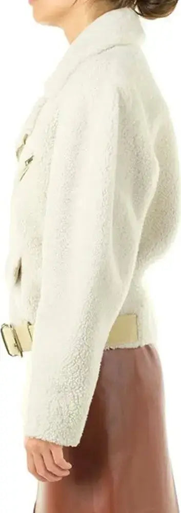 Woman wearing a white textured jacket with a brown skirt