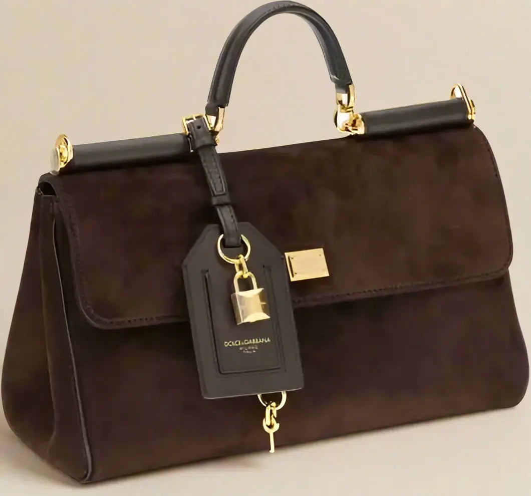 Brown handbag with gold accents and a tag on a white background