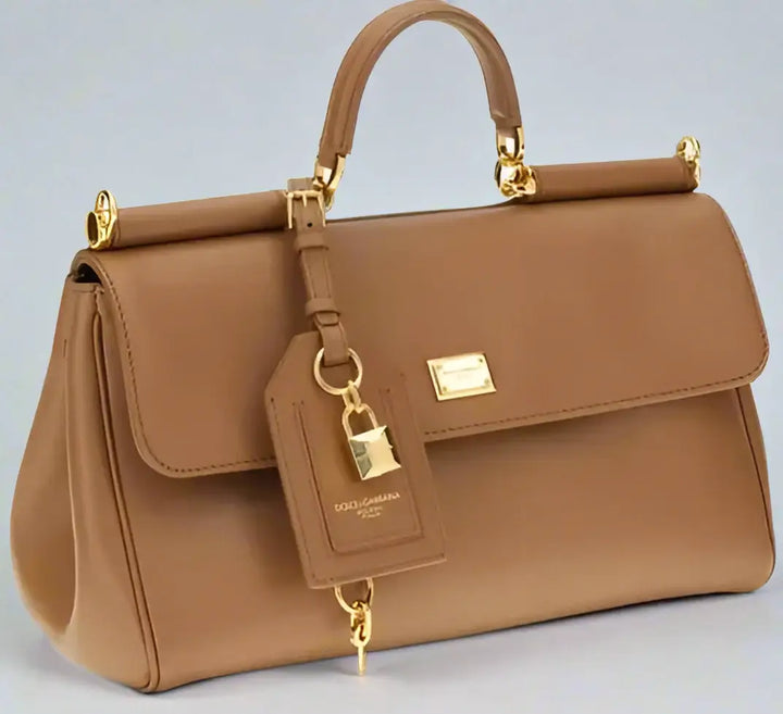 Brown handbag with gold accents on a white background