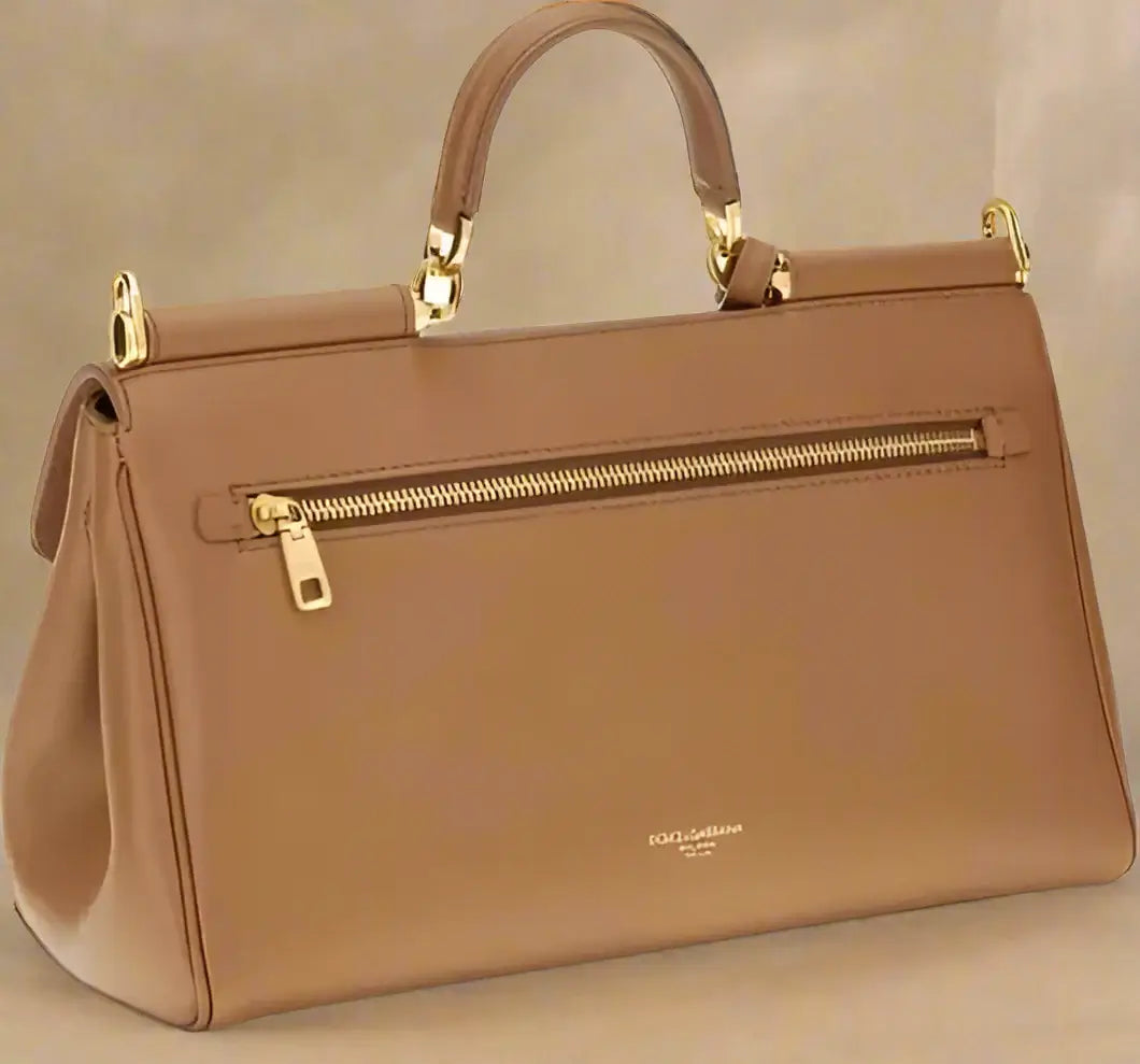 Brown handbag with gold accents on a white background