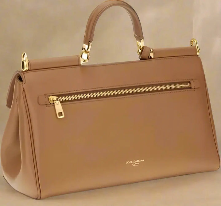 Brown handbag with gold accents on a white background