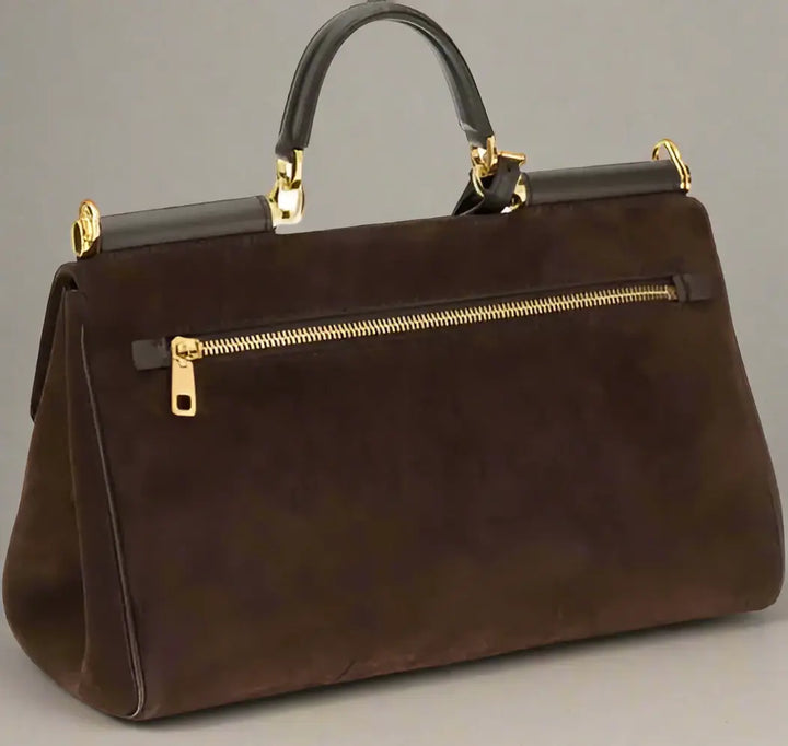 Brown handbag with gold zipper and accents on a white background