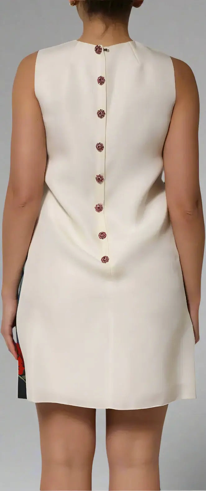 Beige sleeveless dress with button details on a white background