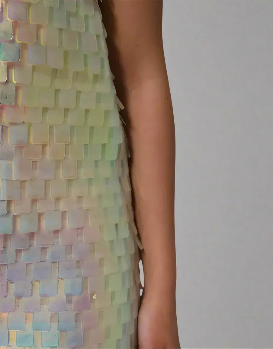 Multicolored sequin dress with a close-up of the pattern on a white background