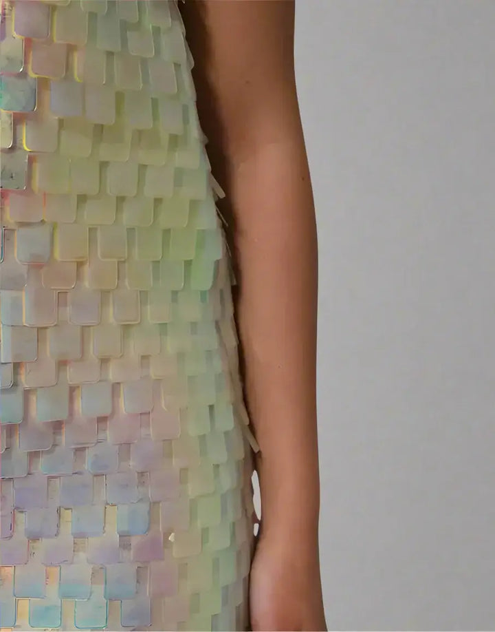 Multicolored sequin dress with a close-up of the pattern on a white background