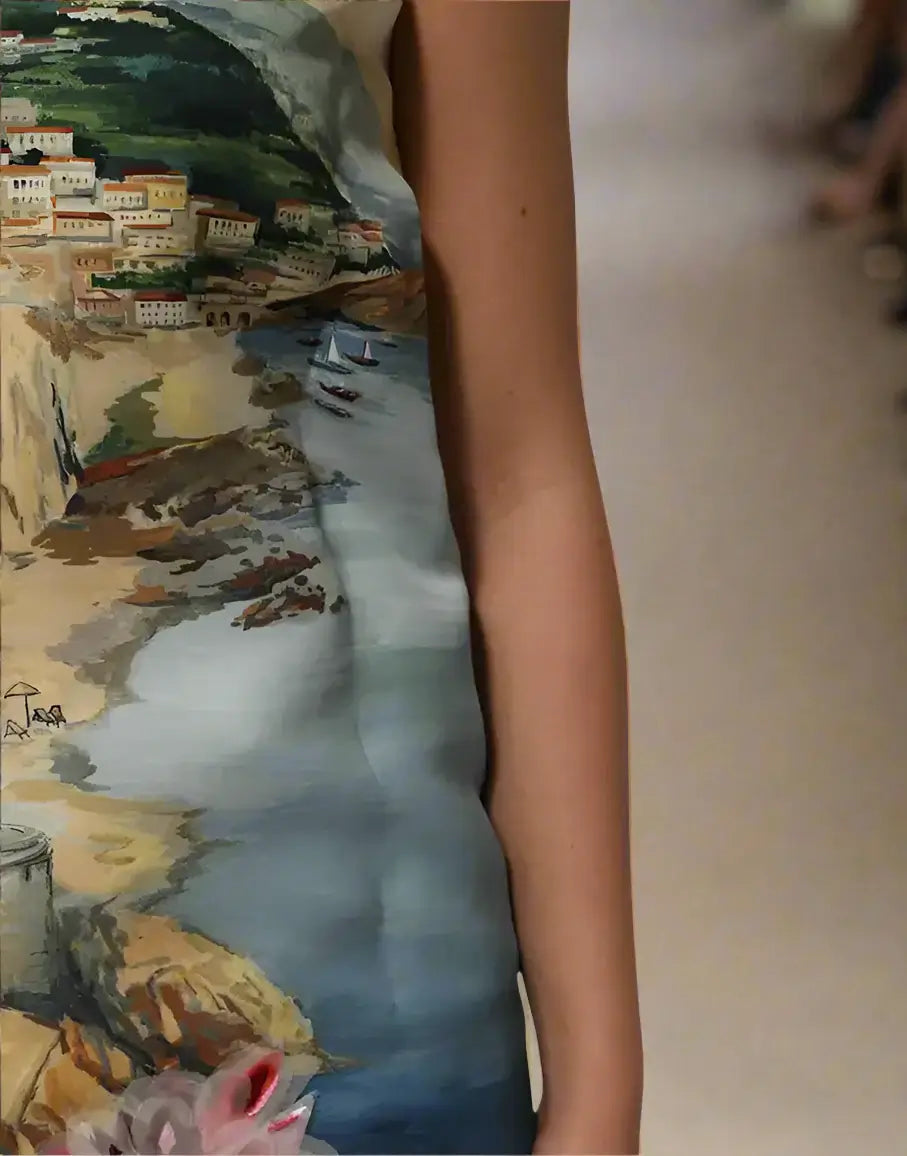Dress with a scenic print of a coastal town and sea.