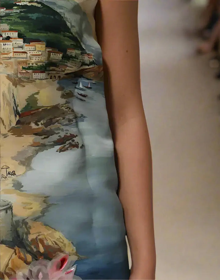 Dress with a scenic print of a coastal town and sea.