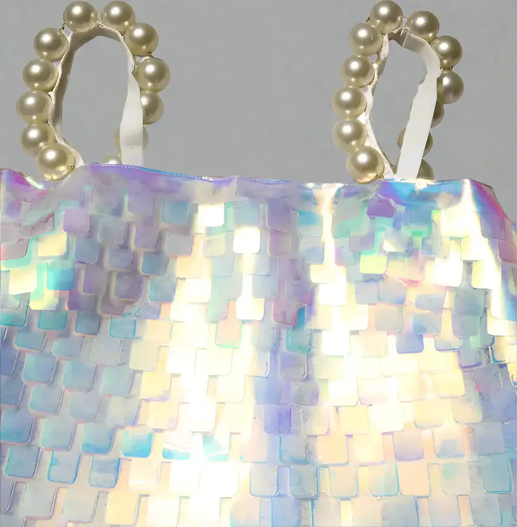 Iridescent sequin bag with pearl handle on a white background