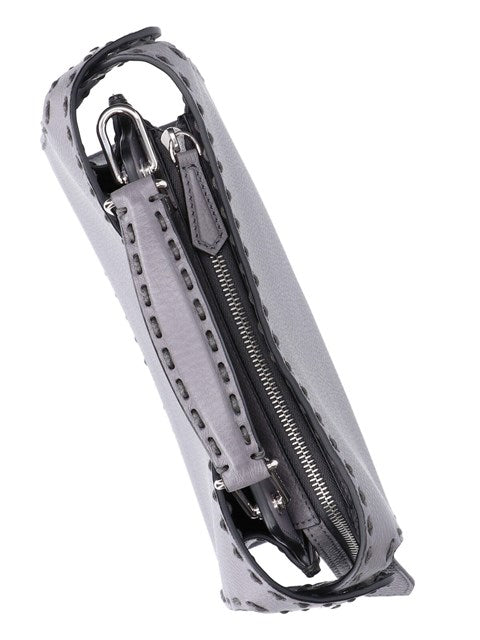 Silver and black bag with zippers on a white background