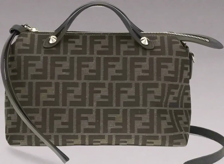 Designer handbag with monogram pattern on a white background