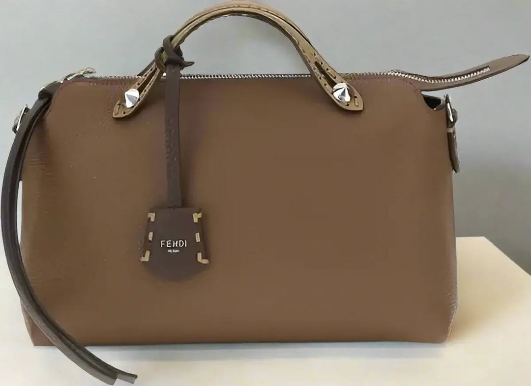 Brown leather handbag with 'Fendi' logo on a white background