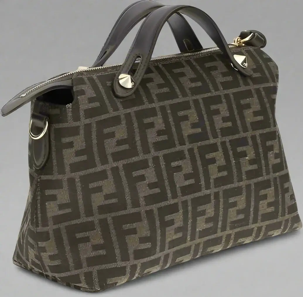 Designer handbag with a prominent logo pattern on a white background