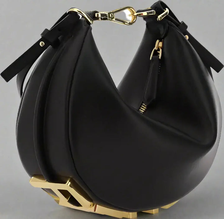 Black handbag with gold accents on a white background
