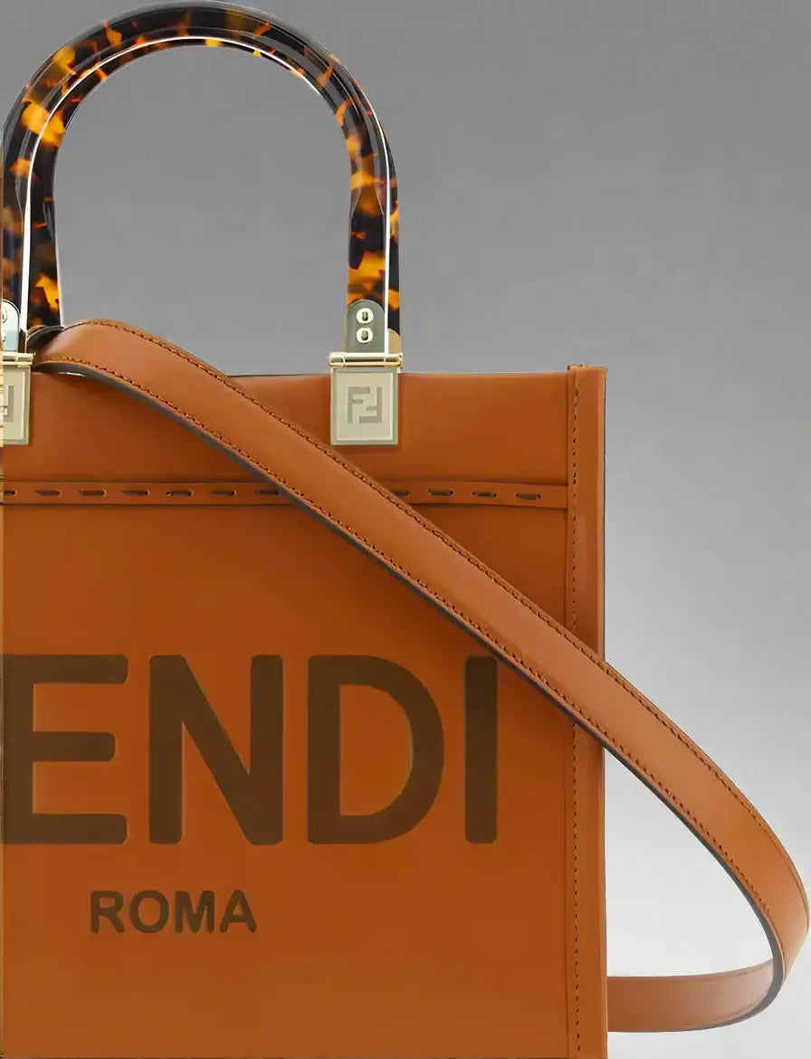 Brown Fendi handbag with tortoiseshell handle on a white background