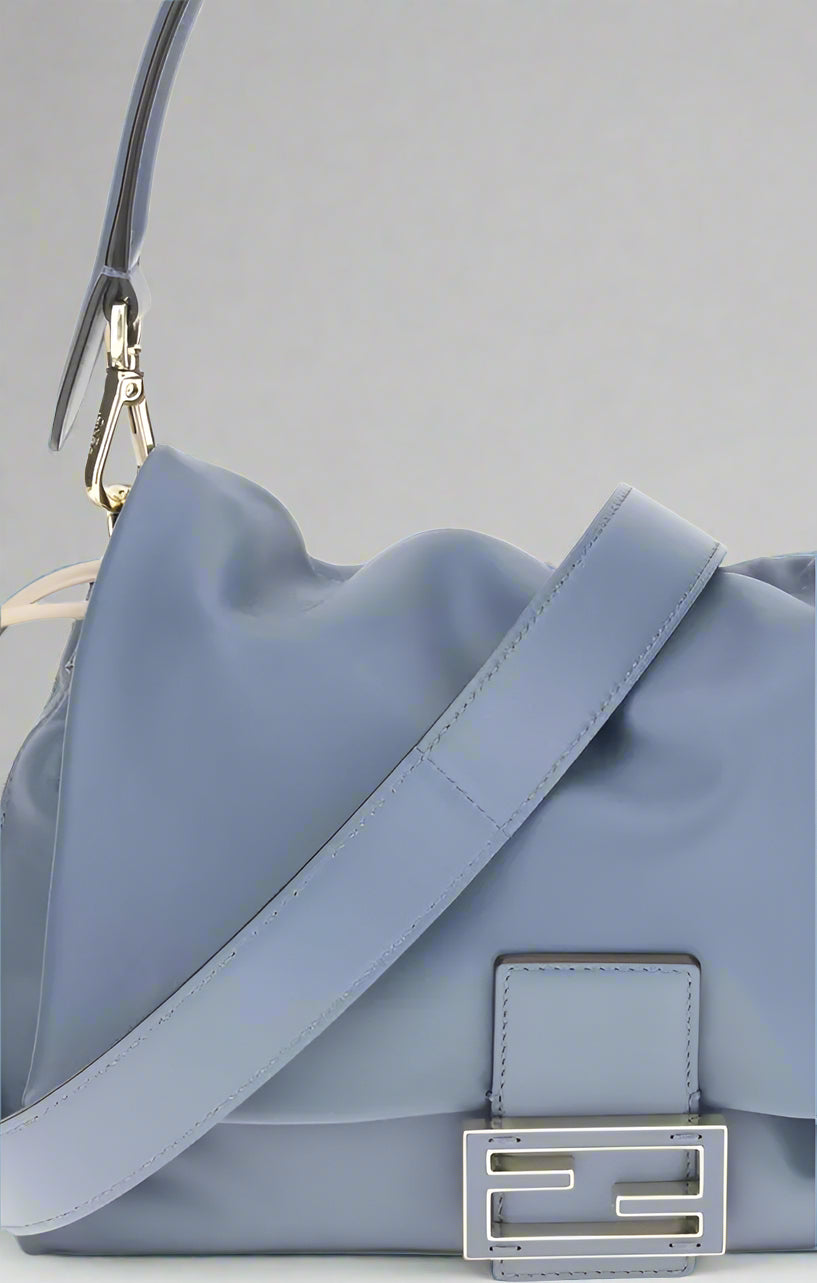 Light blue handbag with a visible brand logo on a white background